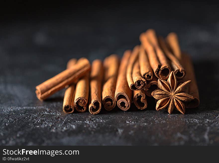 A stack of cinnamon sticks and a star anise. A stack of cinnamon sticks and a star anise.