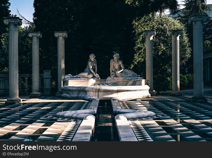 Statues and fountain with Greek pillars in outside gardens. Statues and fountain with Greek pillars in outside gardens.