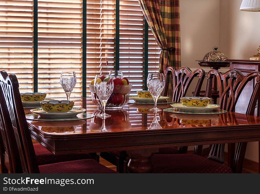 Brown Wooden Chair Near Short Stem Clear Wine Glass