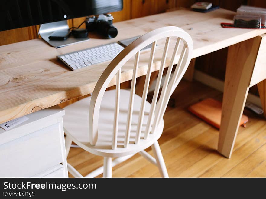 A desk with chair and a computer. A desk with chair and a computer.