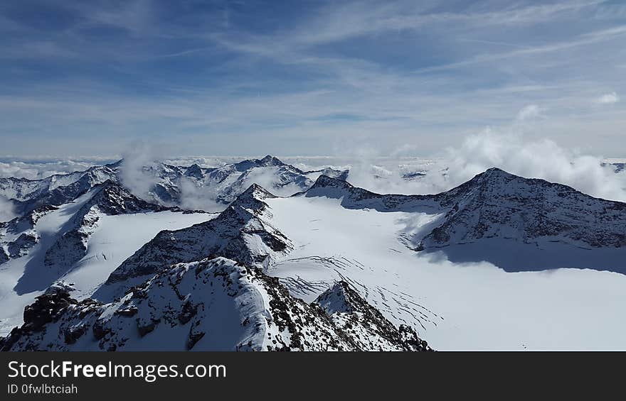 A view over snowy mountain peaks. A view over snowy mountain peaks.