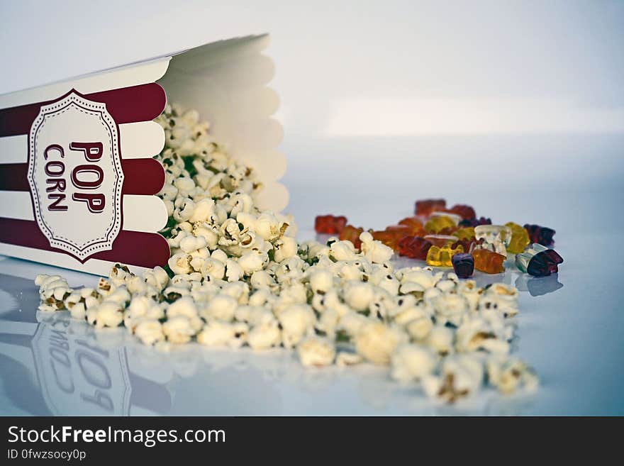 White and Green Pop Corns Beside Red Gummy Bear