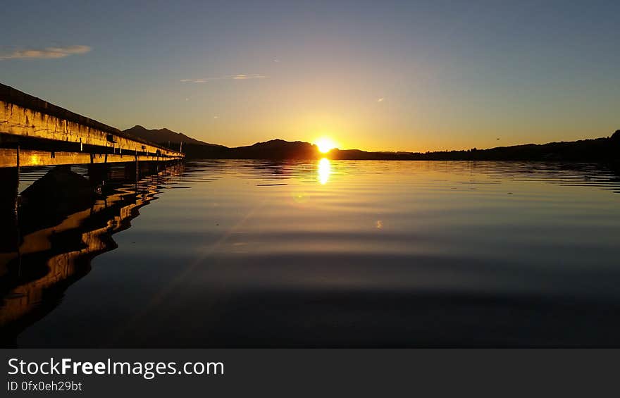 A view of sea with sun setting in the horizon. A view of sea with sun setting in the horizon.