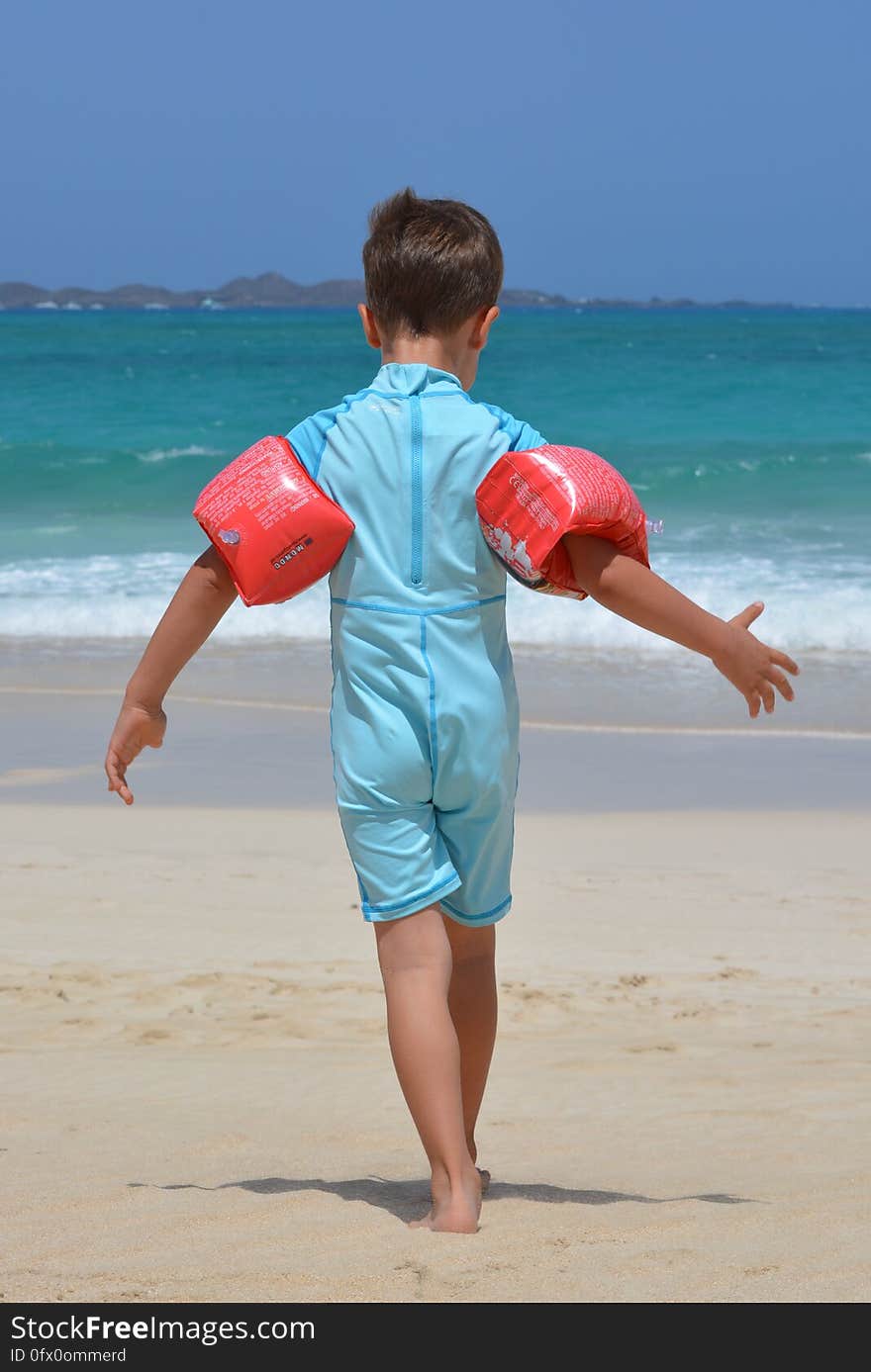 Boy on Blue Onesie on Beach during Day