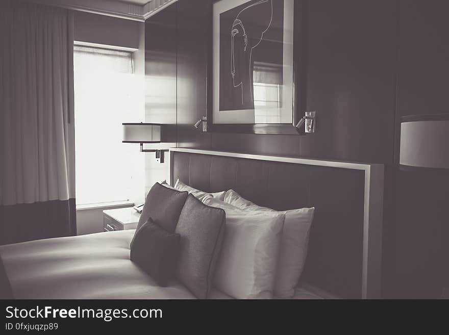 Interior of contemporary bedroom with bed and side tables in black and white. Interior of contemporary bedroom with bed and side tables in black and white.