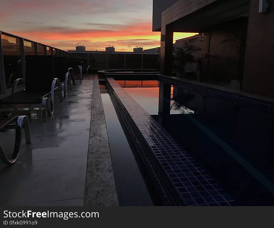 Outside resort with pool at sunset. Outside resort with pool at sunset.