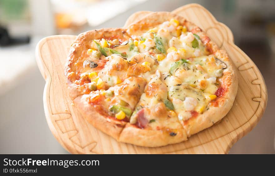 A wooden tray with pizza. A wooden tray with pizza.