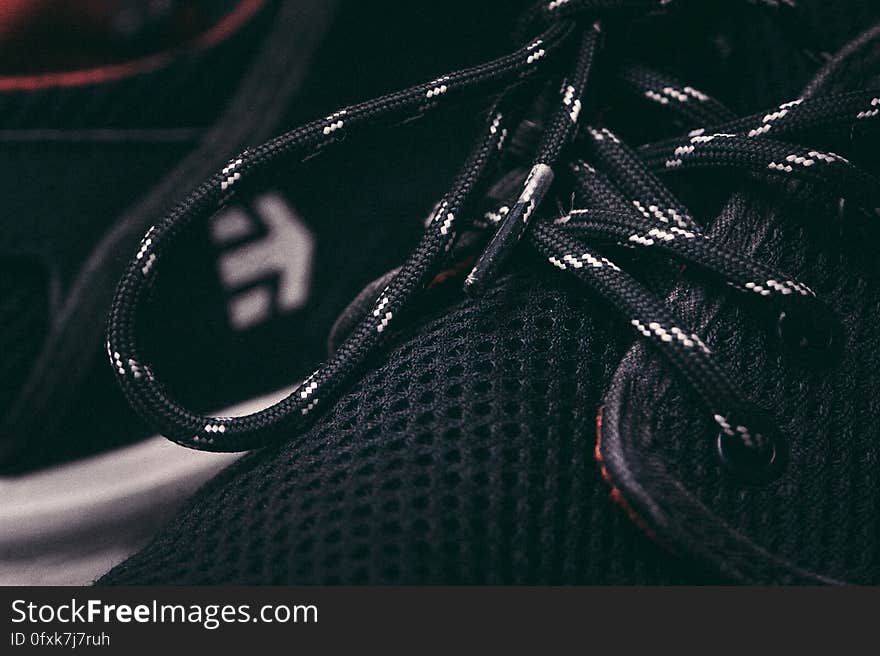 A close up of black and white laces on a sneaker. A close up of black and white laces on a sneaker.