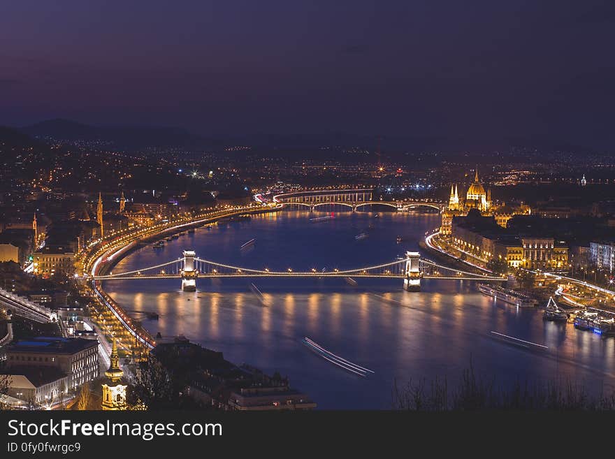 A view over the city of Budapest and the river Danube at night. A view over the city of Budapest and the river Danube at night.