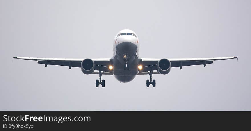 An airplane with landing gears out approaching the runway. An airplane with landing gears out approaching the runway.