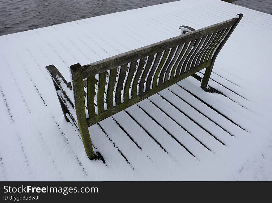 Snow-covered simple wooden bench in Amstelveen, the Netherlands. Snow-covered simple wooden bench in Amstelveen, the Netherlands.