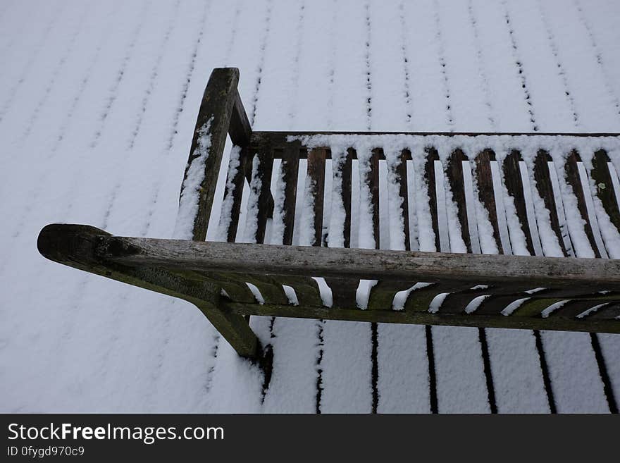 Snow-covered simple wooden bench in Amstelveen, the Netherlands. Snow-covered simple wooden bench in Amstelveen, the Netherlands.