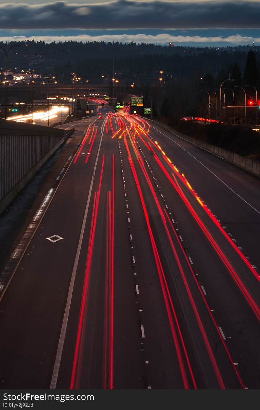 A long exposure of a highway with light trails from car lights. A long exposure of a highway with light trails from car lights.