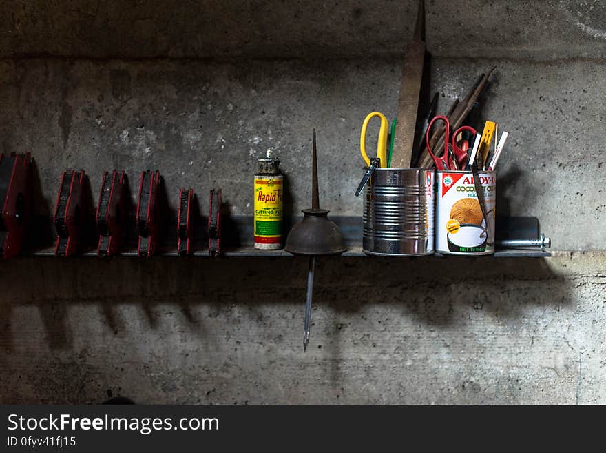 A shelf with tools in a garage. A shelf with tools in a garage.