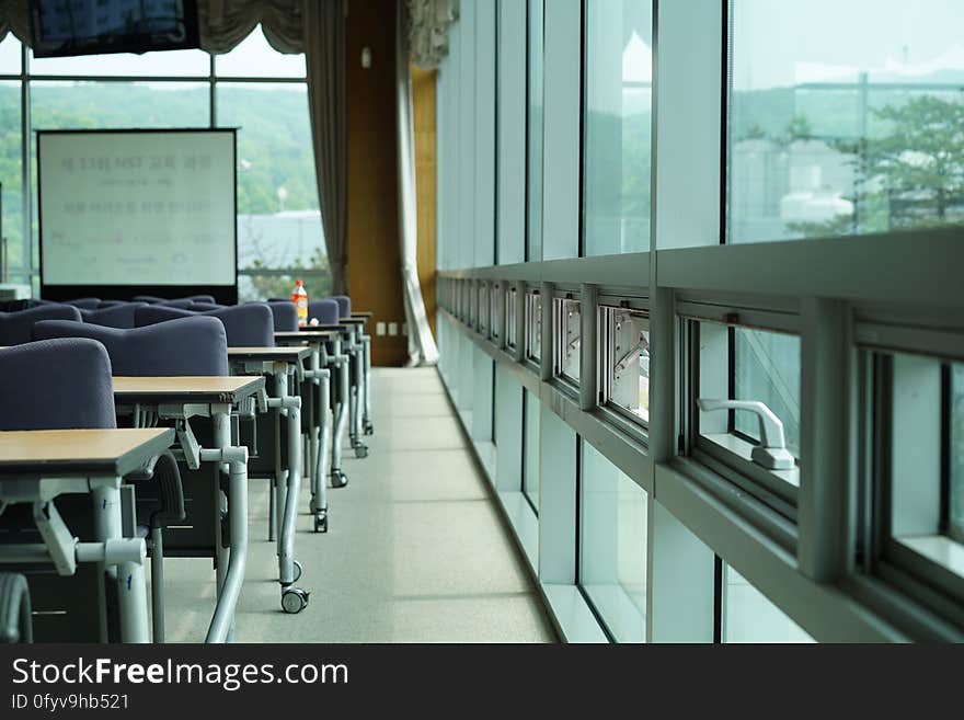 A view inside a classroom with chairs and whiteboard. A view inside a classroom with chairs and whiteboard.