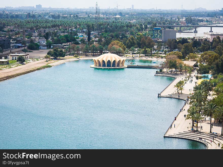 Aerial view of waterfront promenade in urban setting on sunny day. Aerial view of waterfront promenade in urban setting on sunny day.