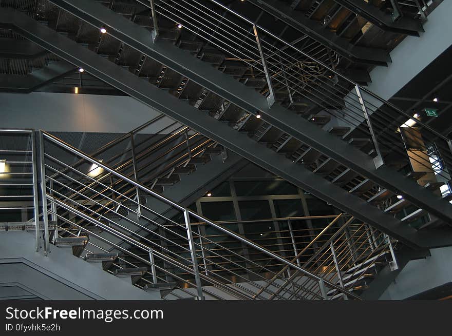 A view in a building with stairways and metal rails. A view in a building with stairways and metal rails.