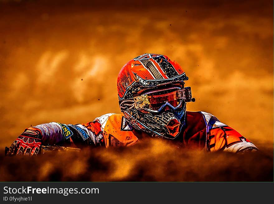 Man Wearing White Black and Orange Motorcross Suit