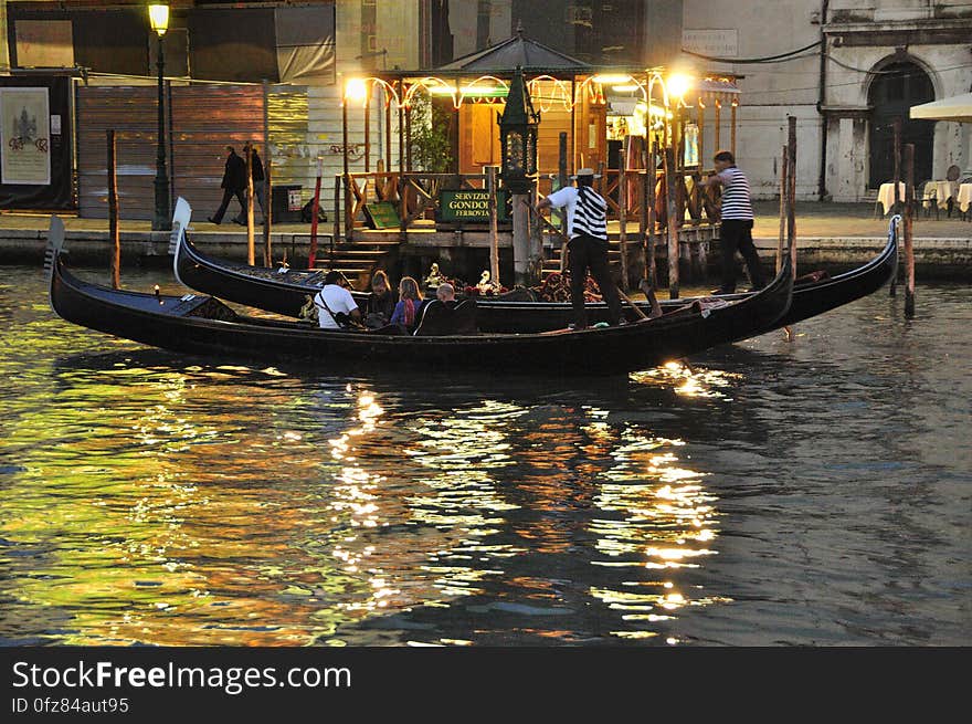 The water streets of Venice are canals which are navigated by gondolas and other small boats. During daylight hours the canals, bridges, and streets of Venice are full of tourists eager to experience the romance of this great travel destination. As night engulfs the town, tourists enjoy some fine dining at one of the many restaurants, leaving the waterways and streets quiet. The gondola is a traditional, flat-bottomed Venetian rowing boat, well suited to the conditions of the Venetian Lagoon. For centuries gondolas were once the chief means of transportation and most common watercraft within Venice. In modern times the iconic boats still have a role in public transport in the city, serving as ferries over the Grand Canal. They are also used in special regattas &#x28;rowing races&#x29; held amongst gondoliers. Their main role, however, is to carry tourists on rides throughout the canals. Gondolas are hand made using 8 different types of wood &#x28;fir, oak, cherry, walnut, elm, mahogany, larch and lime&#x29; and are composed of 280 pieces. The oars are made of beech wood. The left side of the gondola is longer than the right side. This asymmetry causes the gondola to resist the tendency to turn toward the left at the forward stroke. Venetian masks are a centuries-old tradition of Venice. The masks are typically worn during the Carnival of Venice, but have been used on many other occasions in the past, usually as a device for hiding the wearer&#x27;s identity and social status. The mask would permit the wearer to act more freely in cases where he or she wanted to interact with other members of the society outside the bounds of identity and everyday convention. It was thus useful for a variety of purposes, some of them illicit or criminal, others just personal, such as romantic encounters. The water streets of Venice are canals which are navigated by gondolas and other small boats. During daylight hours the canals, bridges, and streets of Venice are full of tourists eager to experience the romance of this great travel destination. As night engulfs the town, tourists enjoy some fine dining at one of the many restaurants, leaving the waterways and streets quiet. The gondola is a traditional, flat-bottomed Venetian rowing boat, well suited to the conditions of the Venetian Lagoon. For centuries gondolas were once the chief means of transportation and most common watercraft within Venice. In modern times the iconic boats still have a role in public transport in the city, serving as ferries over the Grand Canal. They are also used in special regattas &#x28;rowing races&#x29; held amongst gondoliers. Their main role, however, is to carry tourists on rides throughout the canals. Gondolas are hand made using 8 different types of wood &#x28;fir, oak, cherry, walnut, elm, mahogany, larch and lime&#x29; and are composed of 280 pieces. The oars are made of beech wood. The left side of the gondola is longer than the right side. This asymmetry causes the gondola to resist the tendency to turn toward the left at the forward stroke. Venetian masks are a centuries-old tradition of Venice. The masks are typically worn during the Carnival of Venice, but have been used on many other occasions in the past, usually as a device for hiding the wearer&#x27;s identity and social status. The mask would permit the wearer to act more freely in cases where he or she wanted to interact with other members of the society outside the bounds of identity and everyday convention. It was thus useful for a variety of purposes, some of them illicit or criminal, others just personal, such as romantic encounters.