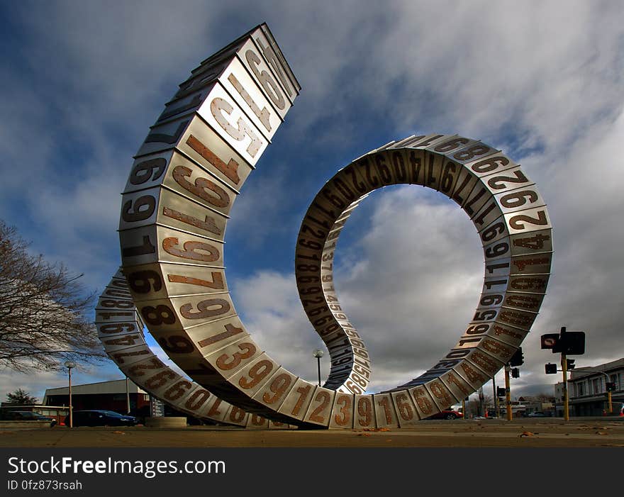 Passing Time, by Auckland sculptor Anton Parsons, consists of a twisting ribbon of randomly linked stainless steel and copper boxes, each box depicting one of the years between the founding of the polytechnic in 1906 and the date of the sculpture&#x27;s installation in 2010. Passing Time, by Auckland sculptor Anton Parsons, consists of a twisting ribbon of randomly linked stainless steel and copper boxes, each box depicting one of the years between the founding of the polytechnic in 1906 and the date of the sculpture&#x27;s installation in 2010.