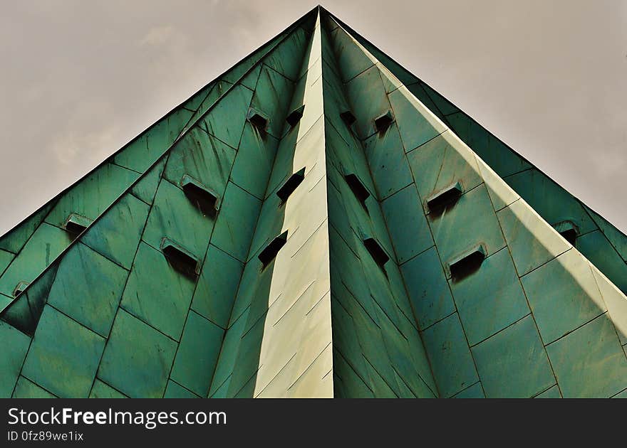 Gray Pyramid Skyscraper Under a Gray Overcast Sky