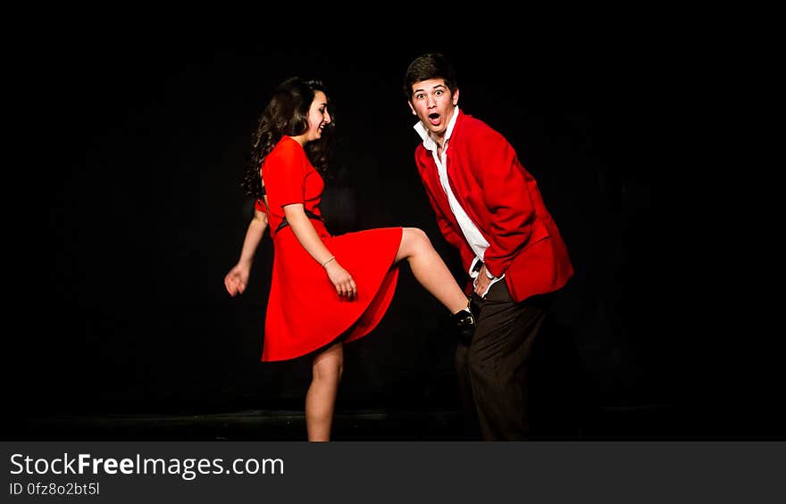 A slapstick comedy show with woman kicking a man in the groin.