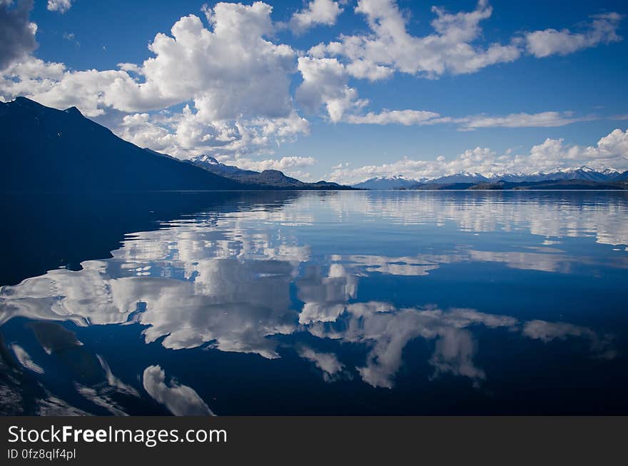 Lake Water Under White and Blue Skies during Daytime