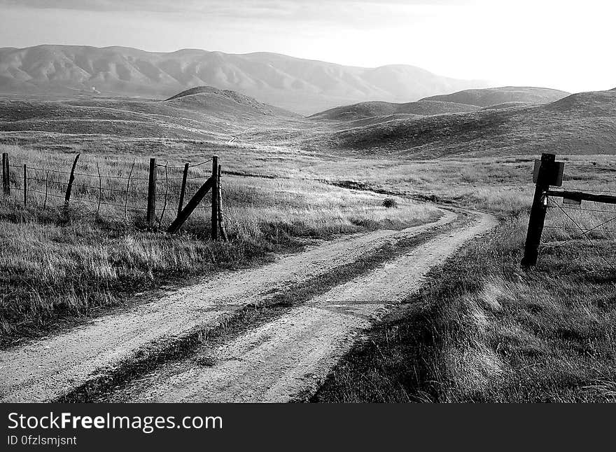 Grayscale Photo of Road and Mountain at Daytime