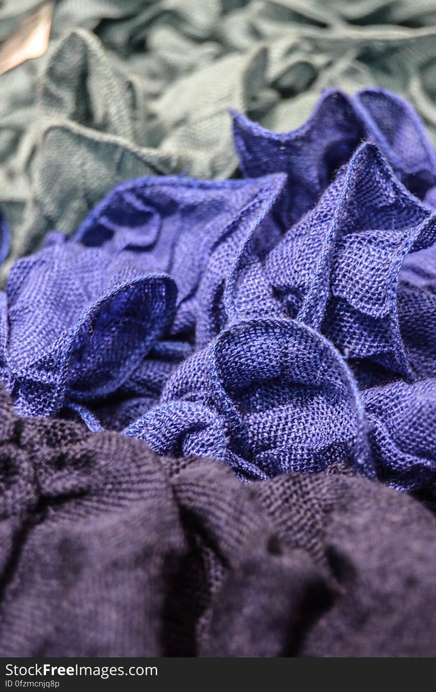 Crumpled grey, blue and purple fabric pieces. Crumpled grey, blue and purple fabric pieces.