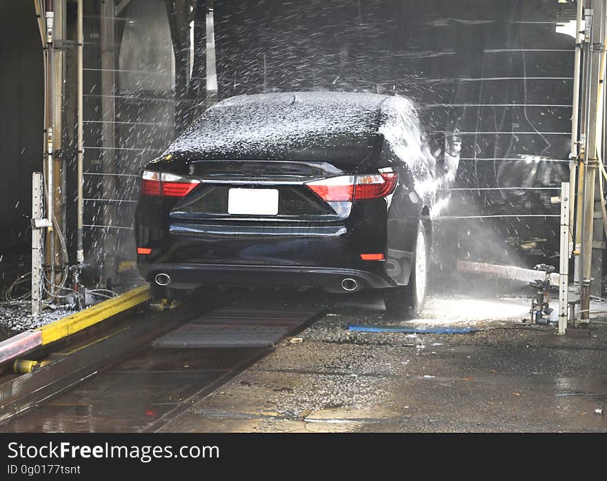 A car in an automatic car wash. A car in an automatic car wash.