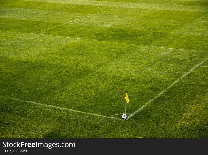 White and Black Soccer Ball on Side of Green Grass Field during Daytime