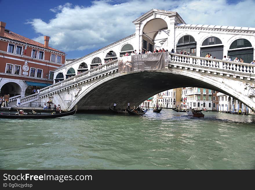 The water streets of Venice are canals which are navigated by gondolas and other small boats. During daylight hours the canals, bridges, and streets of Venice are full of tourists eager to experience the romance of this great travel destination. As night engulfs the town, tourists enjoy some fine dining at one of the many restaurants, leaving the waterways and streets quiet. The gondola is a traditional, flat-bottomed Venetian rowing boat, well suited to the conditions of the Venetian Lagoon. For centuries gondolas were once the chief means of transportation and most common watercraft within Venice. In modern times the iconic boats still have a role in public transport in the city, serving as ferries over the Grand Canal. They are also used in special regattas &#x28;rowing races&#x29; held amongst gondoliers. Their main role, however, is to carry tourists on rides throughout the canals. Gondolas are hand made using 8 different types of wood &#x28;fir, oak, cherry, walnut, elm, mahogany, larch and lime&#x29; and are composed of 280 pieces. The oars are made of beech wood. The left side of the gondola is longer than the right side. This asymmetry causes the gondola to resist the tendency to turn toward the left at the forward stroke. The water streets of Venice are canals which are navigated by gondolas and other small boats. During daylight hours the canals, bridges, and streets of Venice are full of tourists eager to experience the romance of this great travel destination. As night engulfs the town, tourists enjoy some fine dining at one of the many restaurants, leaving the waterways and streets quiet. The gondola is a traditional, flat-bottomed Venetian rowing boat, well suited to the conditions of the Venetian Lagoon. For centuries gondolas were once the chief means of transportation and most common watercraft within Venice. In modern times the iconic boats still have a role in public transport in the city, serving as ferries over the Grand Canal. They are also used in special regattas &#x28;rowing races&#x29; held amongst gondoliers. Their main role, however, is to carry tourists on rides throughout the canals. Gondolas are hand made using 8 different types of wood &#x28;fir, oak, cherry, walnut, elm, mahogany, larch and lime&#x29; and are composed of 280 pieces. The oars are made of beech wood. The left side of the gondola is longer than the right side. This asymmetry causes the gondola to resist the tendency to turn toward the left at the forward stroke.