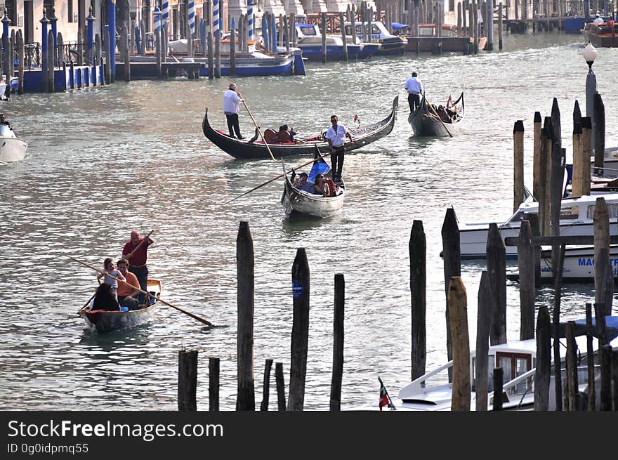 The water streets of Venice are canals which are navigated by gondolas and other small boats. During daylight hours the canals, bridges, and streets of Venice are full of tourists eager to experience the romance of this great travel destination. As night engulfs the town, tourists enjoy some fine dining at one of the many restaurants, leaving the waterways and streets quiet. The gondola is a traditional, flat-bottomed Venetian rowing boat, well suited to the conditions of the Venetian Lagoon. For centuries gondolas were once the chief means of transportation and most common watercraft within Venice. In modern times the iconic boats still have a role in public transport in the city, serving as ferries over the Grand Canal. They are also used in special regattas &#x28;rowing races&#x29; held amongst gondoliers. Their main role, however, is to carry tourists on rides throughout the canals. Gondolas are hand made using 8 different types of wood &#x28;fir, oak, cherry, walnut, elm, mahogany, larch and lime&#x29; and are composed of 280 pieces. The oars are made of beech wood. The left side of the gondola is longer than the right side. This asymmetry causes the gondola to resist the tendency to turn toward the left at the forward stroke. The water streets of Venice are canals which are navigated by gondolas and other small boats. During daylight hours the canals, bridges, and streets of Venice are full of tourists eager to experience the romance of this great travel destination. As night engulfs the town, tourists enjoy some fine dining at one of the many restaurants, leaving the waterways and streets quiet. The gondola is a traditional, flat-bottomed Venetian rowing boat, well suited to the conditions of the Venetian Lagoon. For centuries gondolas were once the chief means of transportation and most common watercraft within Venice. In modern times the iconic boats still have a role in public transport in the city, serving as ferries over the Grand Canal. They are also used in special regattas &#x28;rowing races&#x29; held amongst gondoliers. Their main role, however, is to carry tourists on rides throughout the canals. Gondolas are hand made using 8 different types of wood &#x28;fir, oak, cherry, walnut, elm, mahogany, larch and lime&#x29; and are composed of 280 pieces. The oars are made of beech wood. The left side of the gondola is longer than the right side. This asymmetry causes the gondola to resist the tendency to turn toward the left at the forward stroke.