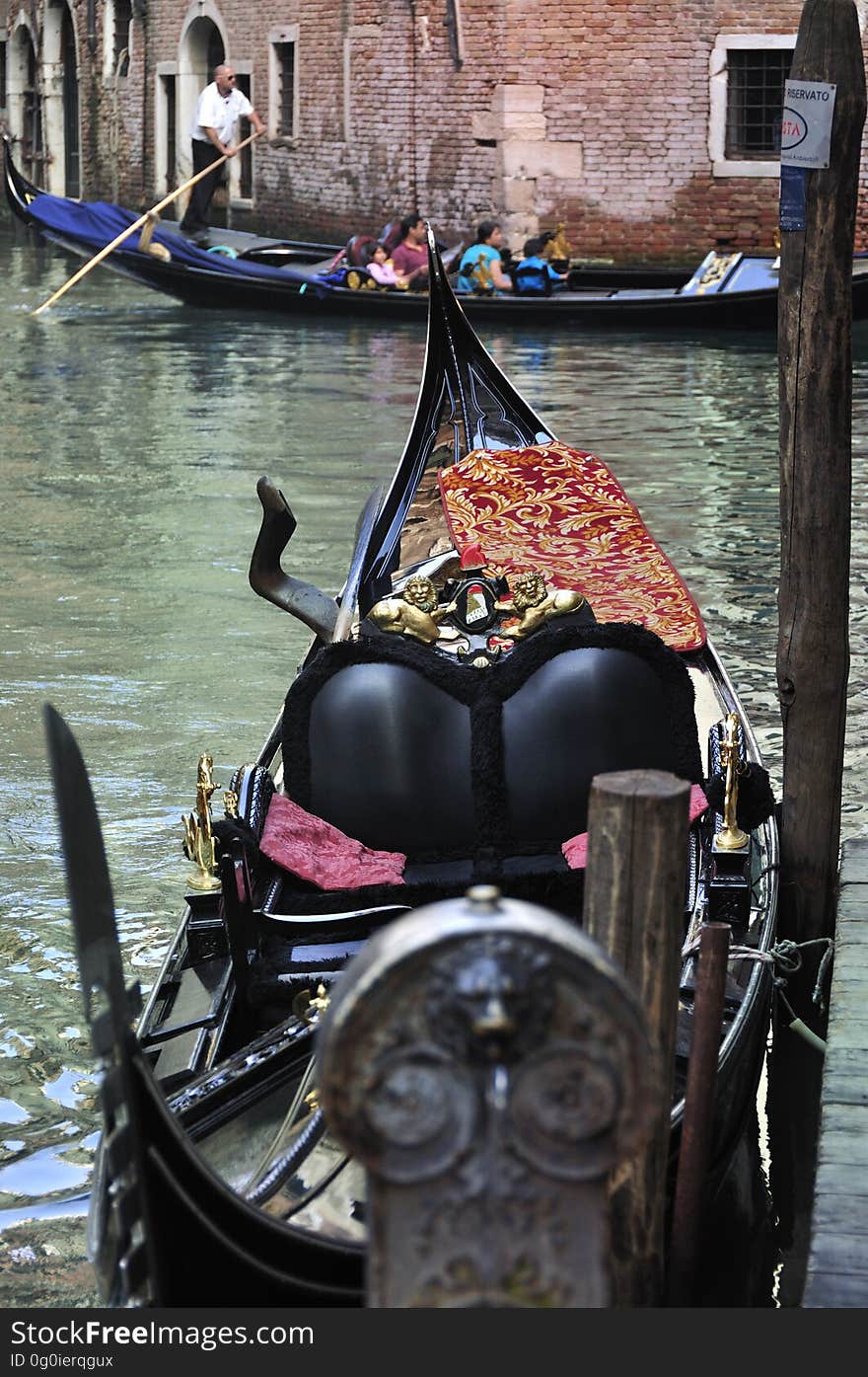 The water streets of Venice are canals which are navigated by gondolas and other small boats. During daylight hours the canals, bridges, and streets of Venice are full of tourists eager to experience the romance of this great travel destination. As night engulfs the town, tourists enjoy some fine dining at one of the many restaurants, leaving the waterways and streets quiet. The gondola is a traditional, flat-bottomed Venetian rowing boat, well suited to the conditions of the Venetian Lagoon. For centuries gondolas were once the chief means of transportation and most common watercraft within Venice. In modern times the iconic boats still have a role in public transport in the city, serving as ferries over the Grand Canal. They are also used in special regattas &#x28;rowing races&#x29; held amongst gondoliers. Their main role, however, is to carry tourists on rides throughout the canals. Gondolas are hand made using 8 different types of wood &#x28;fir, oak, cherry, walnut, elm, mahogany, larch and lime&#x29; and are composed of 280 pieces. The oars are made of beech wood. The left side of the gondola is longer than the right side. This asymmetry causes the gondola to resist the tendency to turn toward the left at the forward stroke. Venetian masks are a centuries-old tradition of Venice. The masks are typically worn during the Carnival of Venice, but have been used on many other occasions in the past, usually as a device for hiding the wearer&#x27;s identity and social status. The mask would permit the wearer to act more freely in cases where he or she wanted to interact with other members of the society outside the bounds of identity and everyday convention. It was thus useful for a variety of purposes, some of them illicit or criminal, others just personal, such as romantic encounters. The water streets of Venice are canals which are navigated by gondolas and other small boats. During daylight hours the canals, bridges, and streets of Venice are full of tourists eager to experience the romance of this great travel destination. As night engulfs the town, tourists enjoy some fine dining at one of the many restaurants, leaving the waterways and streets quiet. The gondola is a traditional, flat-bottomed Venetian rowing boat, well suited to the conditions of the Venetian Lagoon. For centuries gondolas were once the chief means of transportation and most common watercraft within Venice. In modern times the iconic boats still have a role in public transport in the city, serving as ferries over the Grand Canal. They are also used in special regattas &#x28;rowing races&#x29; held amongst gondoliers. Their main role, however, is to carry tourists on rides throughout the canals. Gondolas are hand made using 8 different types of wood &#x28;fir, oak, cherry, walnut, elm, mahogany, larch and lime&#x29; and are composed of 280 pieces. The oars are made of beech wood. The left side of the gondola is longer than the right side. This asymmetry causes the gondola to resist the tendency to turn toward the left at the forward stroke. Venetian masks are a centuries-old tradition of Venice. The masks are typically worn during the Carnival of Venice, but have been used on many other occasions in the past, usually as a device for hiding the wearer&#x27;s identity and social status. The mask would permit the wearer to act more freely in cases where he or she wanted to interact with other members of the society outside the bounds of identity and everyday convention. It was thus useful for a variety of purposes, some of them illicit or criminal, others just personal, such as romantic encounters.