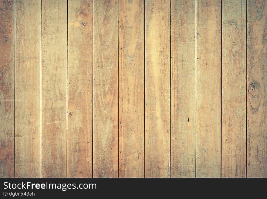 Background created by wooden planks joined by the tongue and groove method showing cracks, knots and grain. Background created by wooden planks joined by the tongue and groove method showing cracks, knots and grain.