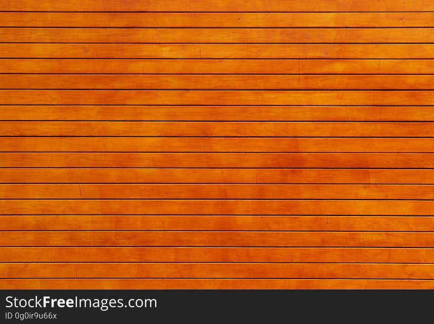 An orange color wood background.