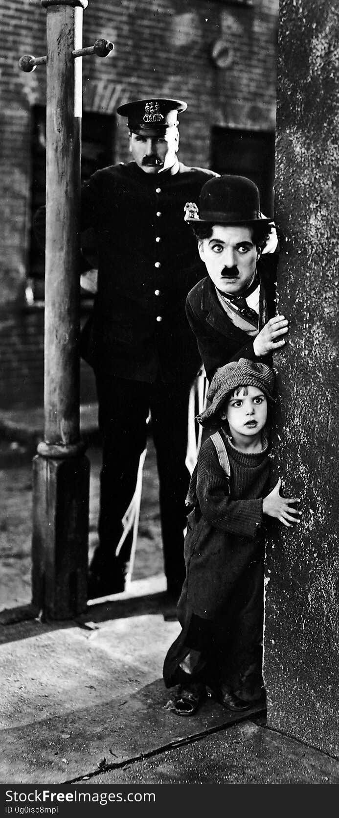 Photo from the movie The Kid with Tom Wilson, Charles Chaplin and Jackie Coogan, year 1921. Photo from the movie The Kid with Tom Wilson, Charles Chaplin and Jackie Coogan, year 1921.