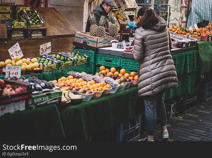 A vegetable vendor selling fruits and vegetables in the market.