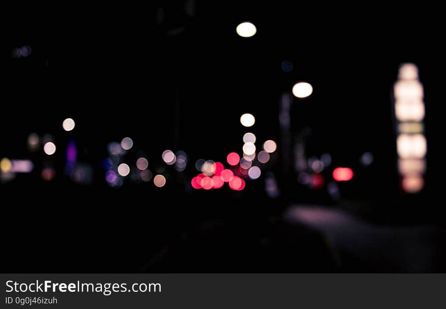 Red and white bokeh lights in city street at night.