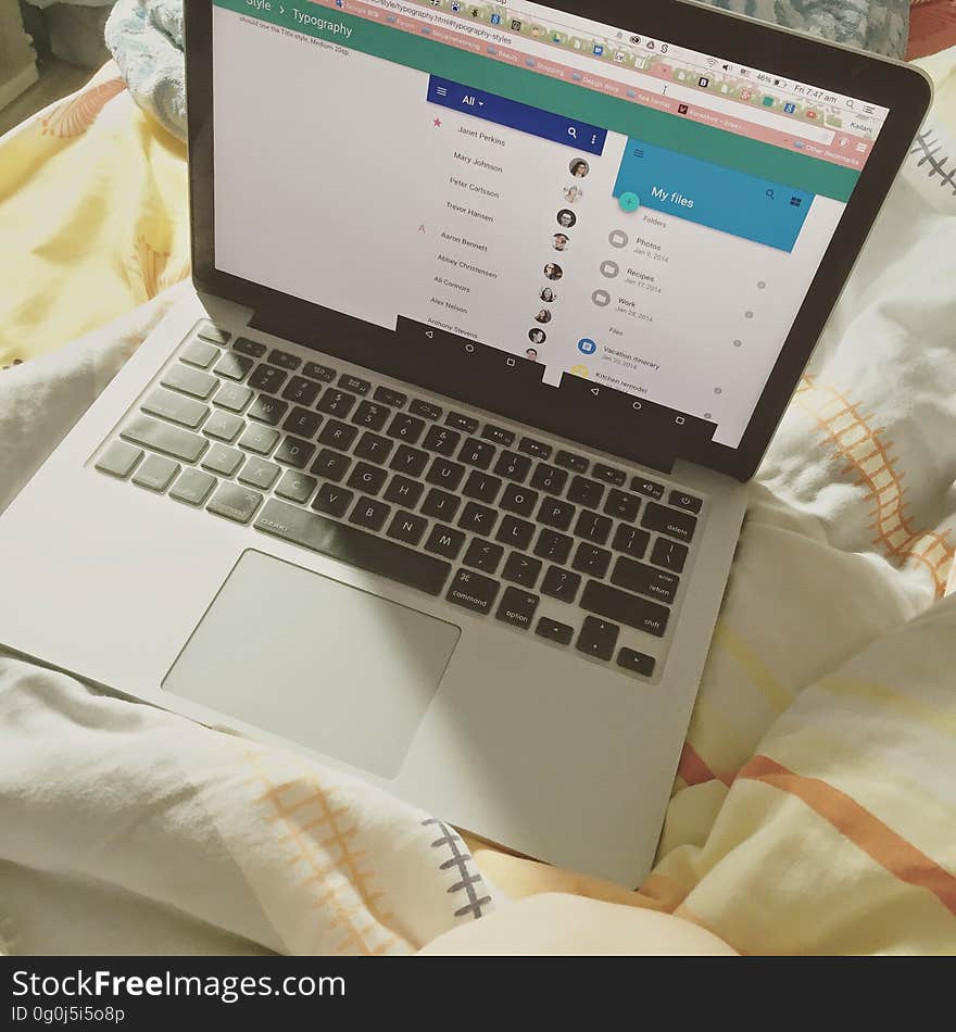 A laptop on the sheets in bed. A laptop on the sheets in bed.