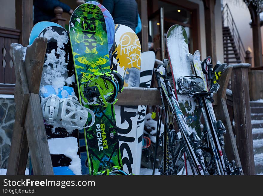 Snow boards and skis against the wall of a skiing lodge. Snow boards and skis against the wall of a skiing lodge.