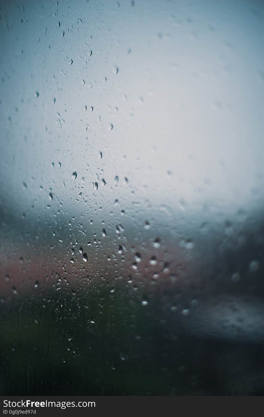 A glass with rain drops gathered on the surface. A glass with rain drops gathered on the surface.