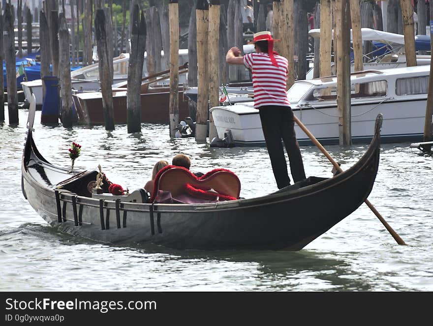 The water streets of Venice are canals which are navigated by gondolas and other small boats. During daylight hours the canals, bridges, and streets of Venice are full of tourists eager to experience the romance of this great travel destination. As night engulfs the town, tourists enjoy some fine dining at one of the many restaurants, leaving the waterways and streets quiet. The gondola is a traditional, flat-bottomed Venetian rowing boat, well suited to the conditions of the Venetian Lagoon. For centuries gondolas were once the chief means of transportation and most common watercraft within Venice. In modern times the iconic boats still have a role in public transport in the city, serving as ferries over the Grand Canal. They are also used in special regattas &#x28;rowing races&#x29; held amongst gondoliers. Their main role, however, is to carry tourists on rides throughout the canals. Gondolas are hand made using 8 different types of wood &#x28;fir, oak, cherry, walnut, elm, mahogany, larch and lime&#x29; and are composed of 280 pieces. The oars are made of beech wood. The left side of the gondola is longer than the right side. This asymmetry causes the gondola to resist the tendency to turn toward the left at the forward stroke. The water streets of Venice are canals which are navigated by gondolas and other small boats. During daylight hours the canals, bridges, and streets of Venice are full of tourists eager to experience the romance of this great travel destination. As night engulfs the town, tourists enjoy some fine dining at one of the many restaurants, leaving the waterways and streets quiet. The gondola is a traditional, flat-bottomed Venetian rowing boat, well suited to the conditions of the Venetian Lagoon. For centuries gondolas were once the chief means of transportation and most common watercraft within Venice. In modern times the iconic boats still have a role in public transport in the city, serving as ferries over the Grand Canal. They are also used in special regattas &#x28;rowing races&#x29; held amongst gondoliers. Their main role, however, is to carry tourists on rides throughout the canals. Gondolas are hand made using 8 different types of wood &#x28;fir, oak, cherry, walnut, elm, mahogany, larch and lime&#x29; and are composed of 280 pieces. The oars are made of beech wood. The left side of the gondola is longer than the right side. This asymmetry causes the gondola to resist the tendency to turn toward the left at the forward stroke.