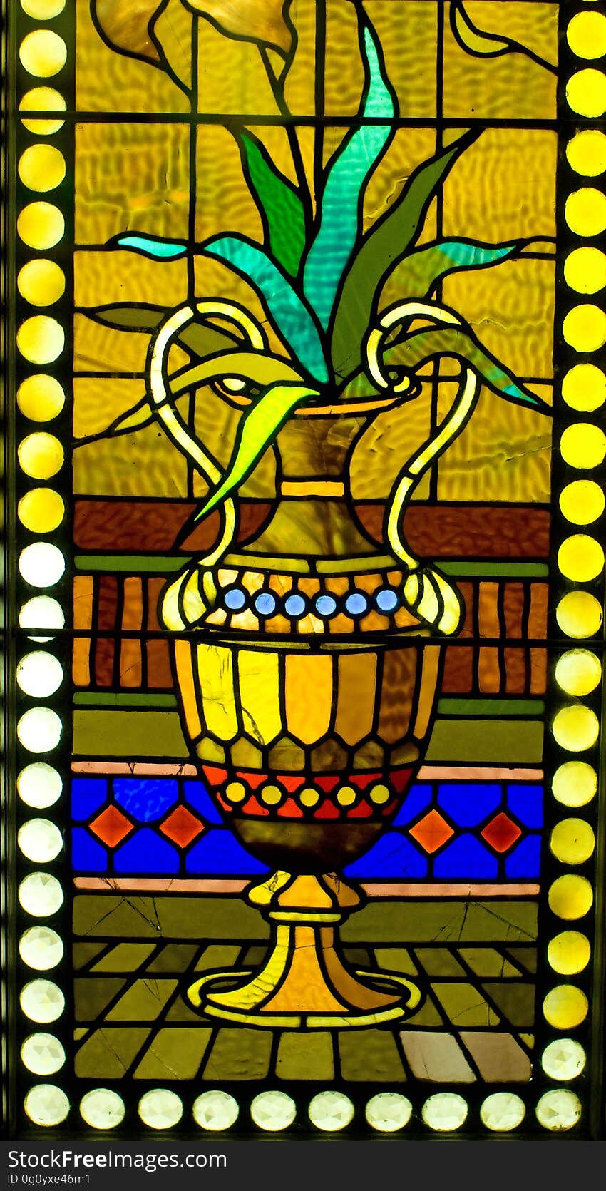 Stained glass window detail of a plant in an urn at the Smith Museum of Stained Glass Windows at Navy Pier in Chicago, Illinois. This gem of a free museum ought to be on your tour of Chicago.