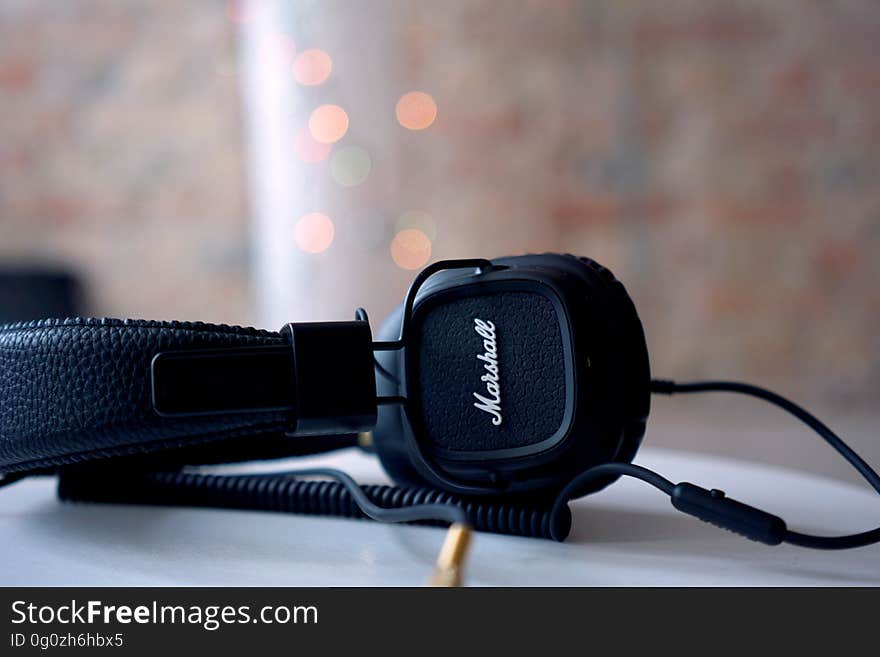 A pair of headphones on a table. A pair of headphones on a table.