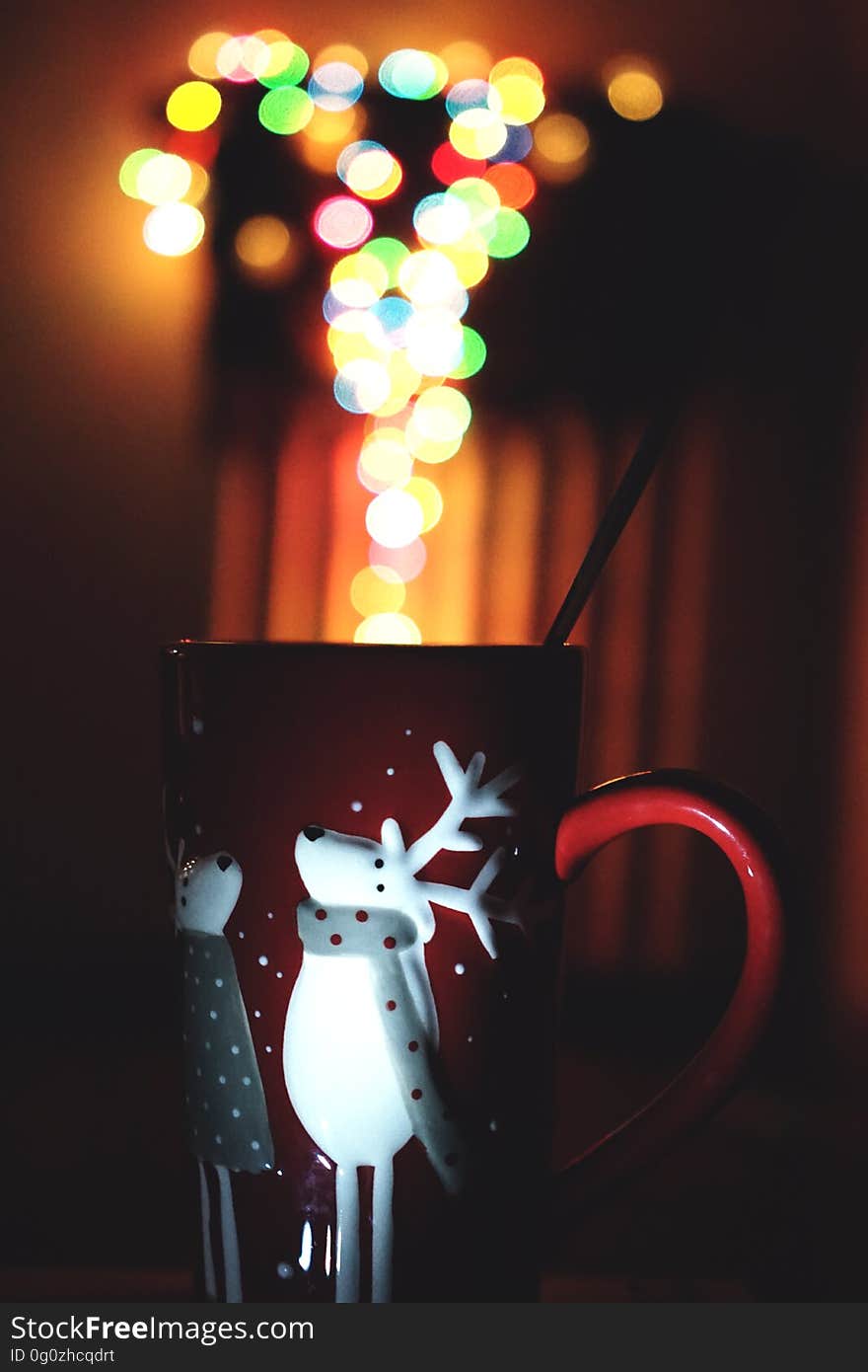 A close up of a Christmas cup with blurred lights.