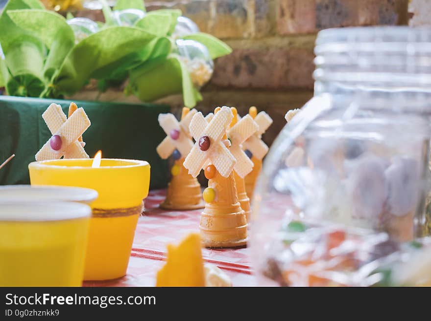 A table setting with cakes in the shape of windmill and other desserts. A table setting with cakes in the shape of windmill and other desserts.