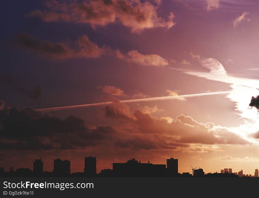 Violet color sky with clouds over a city. Violet color sky with clouds over a city.