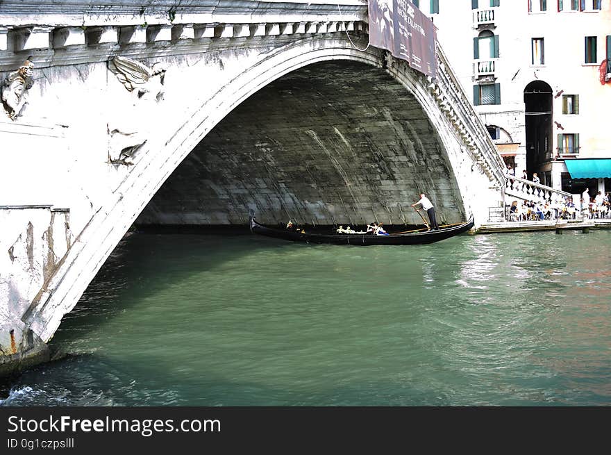 The water streets of Venice are canals which are navigated by gondolas and other small boats. During daylight hours the canals, bridges, and streets of Venice are full of tourists eager to experience the romance of this great travel destination. As night engulfs the town, tourists enjoy some fine dining at one of the many restaurants, leaving the waterways and streets quiet. The gondola is a traditional, flat-bottomed Venetian rowing boat, well suited to the conditions of the Venetian Lagoon. For centuries gondolas were once the chief means of transportation and most common watercraft within Venice. In modern times the iconic boats still have a role in public transport in the city, serving as ferries over the Grand Canal. They are also used in special regattas &#x28;rowing races&#x29; held amongst gondoliers. Their main role, however, is to carry tourists on rides throughout the canals. Gondolas are hand made using 8 different types of wood &#x28;fir, oak, cherry, walnut, elm, mahogany, larch and lime&#x29; and are composed of 280 pieces. The oars are made of beech wood. The left side of the gondola is longer than the right side. This asymmetry causes the gondola to resist the tendency to turn toward the left at the forward stroke. The water streets of Venice are canals which are navigated by gondolas and other small boats. During daylight hours the canals, bridges, and streets of Venice are full of tourists eager to experience the romance of this great travel destination. As night engulfs the town, tourists enjoy some fine dining at one of the many restaurants, leaving the waterways and streets quiet. The gondola is a traditional, flat-bottomed Venetian rowing boat, well suited to the conditions of the Venetian Lagoon. For centuries gondolas were once the chief means of transportation and most common watercraft within Venice. In modern times the iconic boats still have a role in public transport in the city, serving as ferries over the Grand Canal. They are also used in special regattas &#x28;rowing races&#x29; held amongst gondoliers. Their main role, however, is to carry tourists on rides throughout the canals. Gondolas are hand made using 8 different types of wood &#x28;fir, oak, cherry, walnut, elm, mahogany, larch and lime&#x29; and are composed of 280 pieces. The oars are made of beech wood. The left side of the gondola is longer than the right side. This asymmetry causes the gondola to resist the tendency to turn toward the left at the forward stroke.