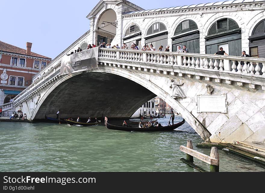 The water streets of Venice are canals which are navigated by gondolas and other small boats. During daylight hours the canals, bridges, and streets of Venice are full of tourists eager to experience the romance of this great travel destination. As night engulfs the town, tourists enjoy some fine dining at one of the many restaurants, leaving the waterways and streets quiet. The gondola is a traditional, flat-bottomed Venetian rowing boat, well suited to the conditions of the Venetian Lagoon. For centuries gondolas were once the chief means of transportation and most common watercraft within Venice. In modern times the iconic boats still have a role in public transport in the city, serving as ferries over the Grand Canal. They are also used in special regattas &#x28;rowing races&#x29; held amongst gondoliers. Their main role, however, is to carry tourists on rides throughout the canals. Gondolas are hand made using 8 different types of wood &#x28;fir, oak, cherry, walnut, elm, mahogany, larch and lime&#x29; and are composed of 280 pieces. The oars are made of beech wood. The left side of the gondola is longer than the right side. This asymmetry causes the gondola to resist the tendency to turn toward the left at the forward stroke. The water streets of Venice are canals which are navigated by gondolas and other small boats. During daylight hours the canals, bridges, and streets of Venice are full of tourists eager to experience the romance of this great travel destination. As night engulfs the town, tourists enjoy some fine dining at one of the many restaurants, leaving the waterways and streets quiet. The gondola is a traditional, flat-bottomed Venetian rowing boat, well suited to the conditions of the Venetian Lagoon. For centuries gondolas were once the chief means of transportation and most common watercraft within Venice. In modern times the iconic boats still have a role in public transport in the city, serving as ferries over the Grand Canal. They are also used in special regattas &#x28;rowing races&#x29; held amongst gondoliers. Their main role, however, is to carry tourists on rides throughout the canals. Gondolas are hand made using 8 different types of wood &#x28;fir, oak, cherry, walnut, elm, mahogany, larch and lime&#x29; and are composed of 280 pieces. The oars are made of beech wood. The left side of the gondola is longer than the right side. This asymmetry causes the gondola to resist the tendency to turn toward the left at the forward stroke.